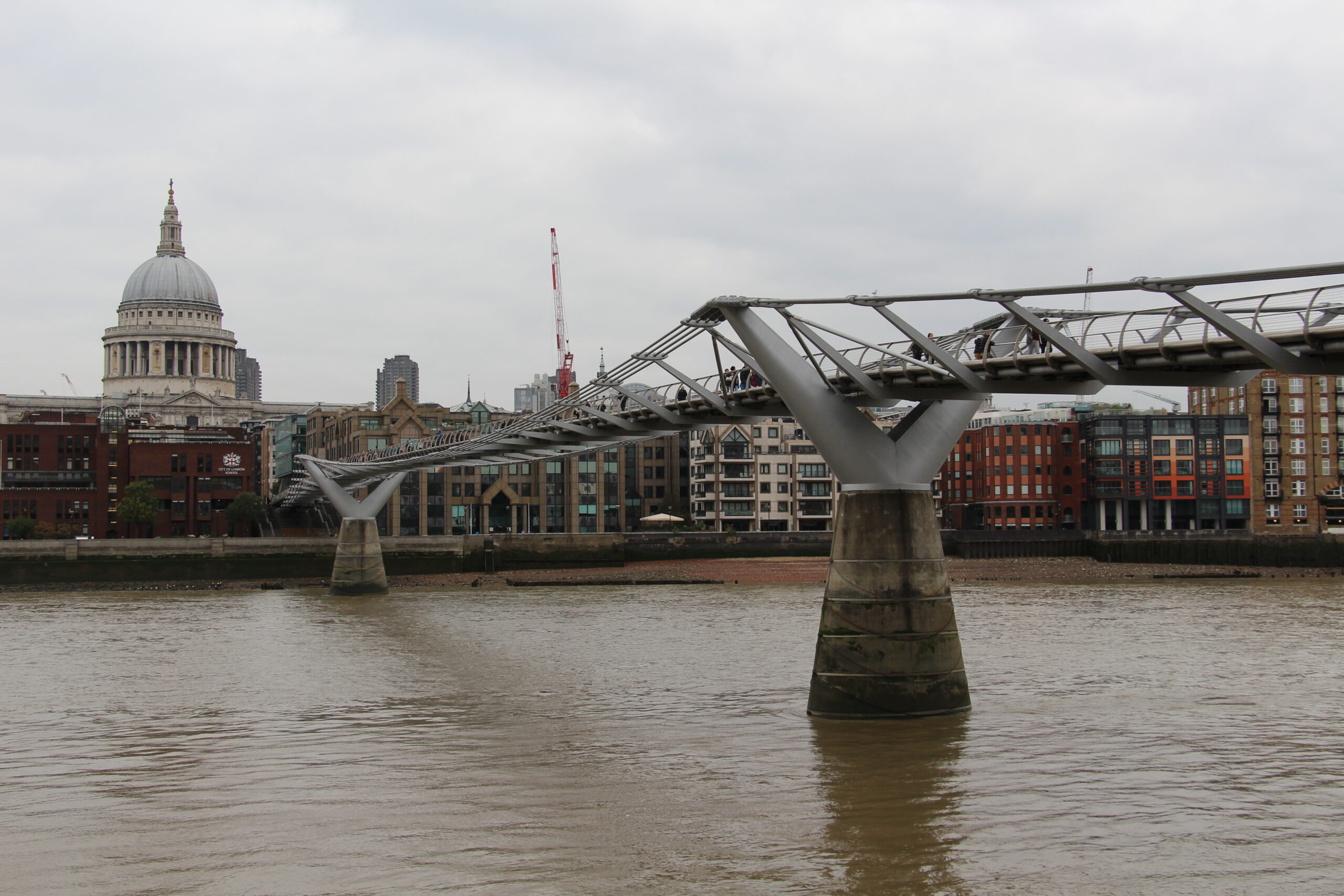 Millennium Bridge crossing the Thames with St Paul's Cathedral behind it