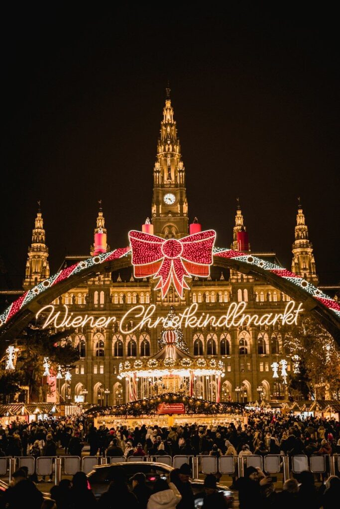 A large building with a christmas light display in front of it