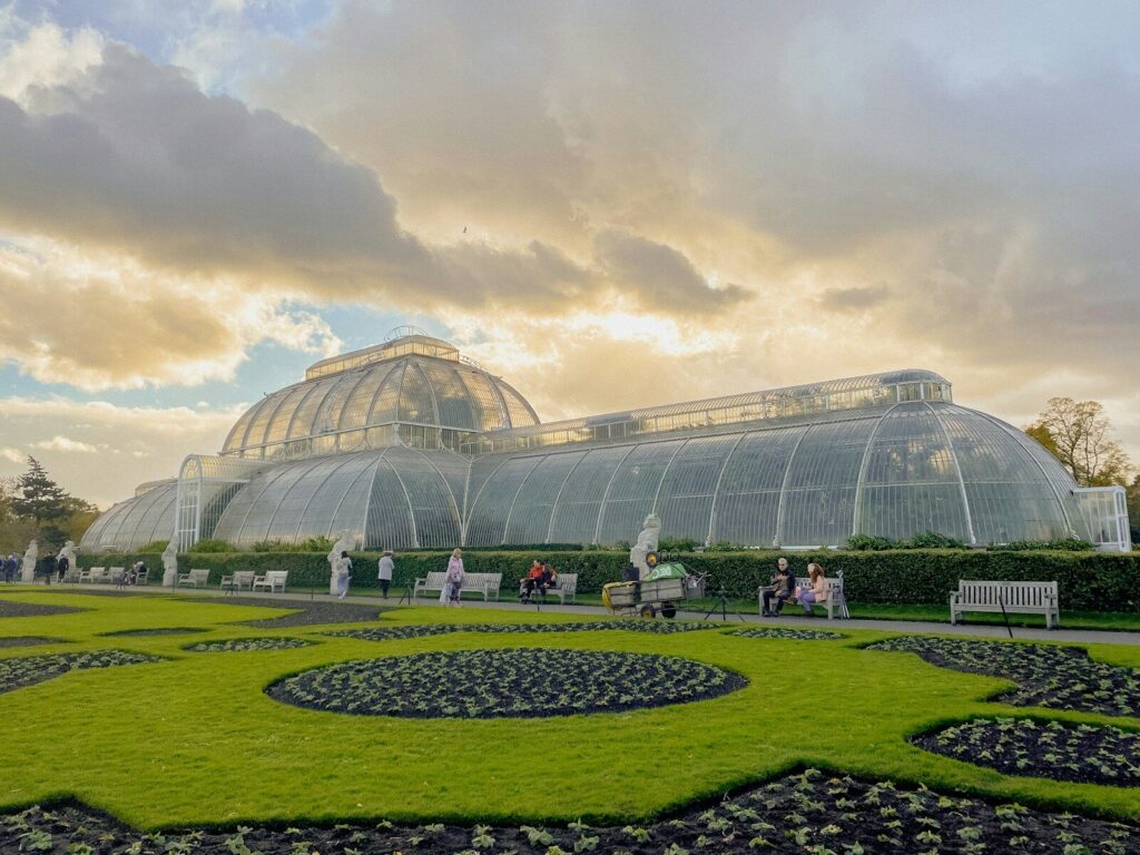 a green house with a circular garden in front of it